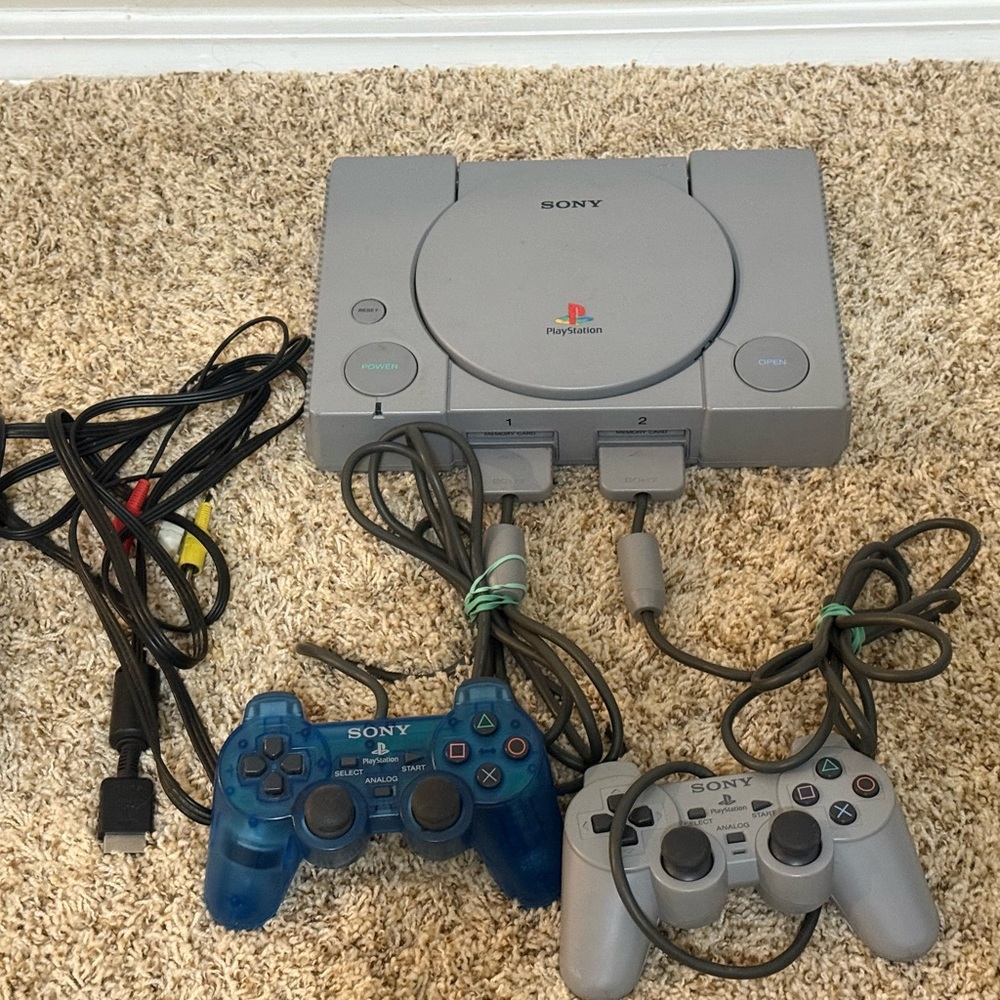 Sony PlayStation Console with Gray and Blue Controllers